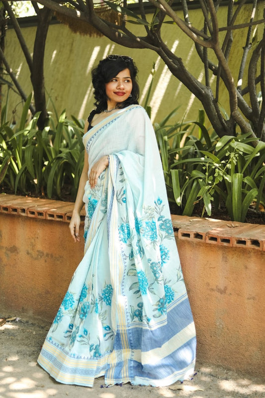 Woman in a pastel blue floral printed khadi cotton saree full picture