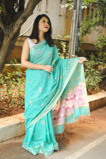 Woman in blue linen cotton saree looking u