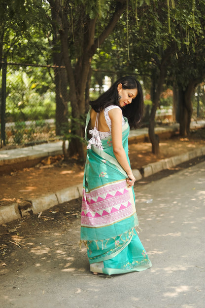 Woman in blue linen cotton saree adjusting her sari