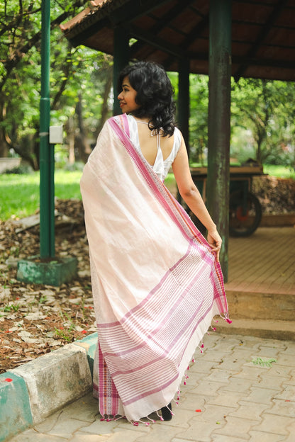 woman in a pastel pink cotton saree showing the pallu