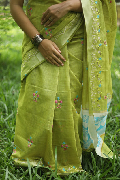 Woman in green linen cotton sari showing the drape