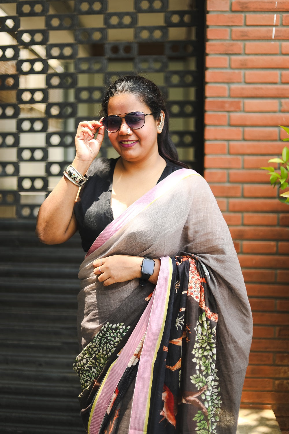 Woman in a saree and sunglasses