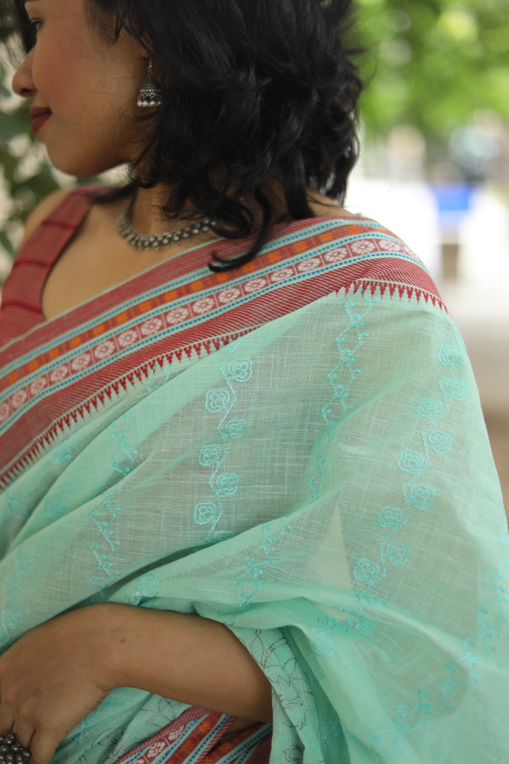 Embroidery on the light green cotton saree