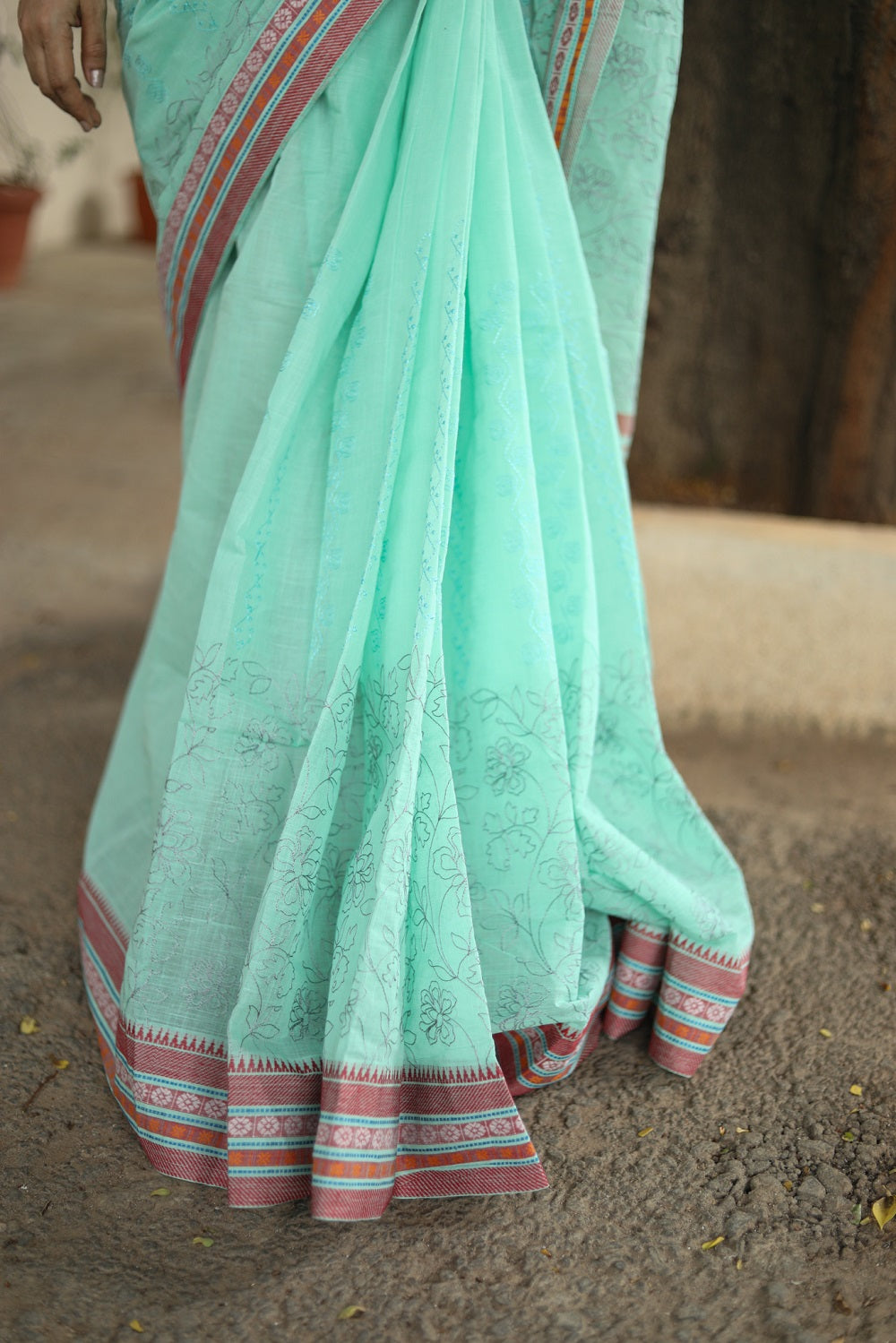 Pastel green cotton sari drape on a woman