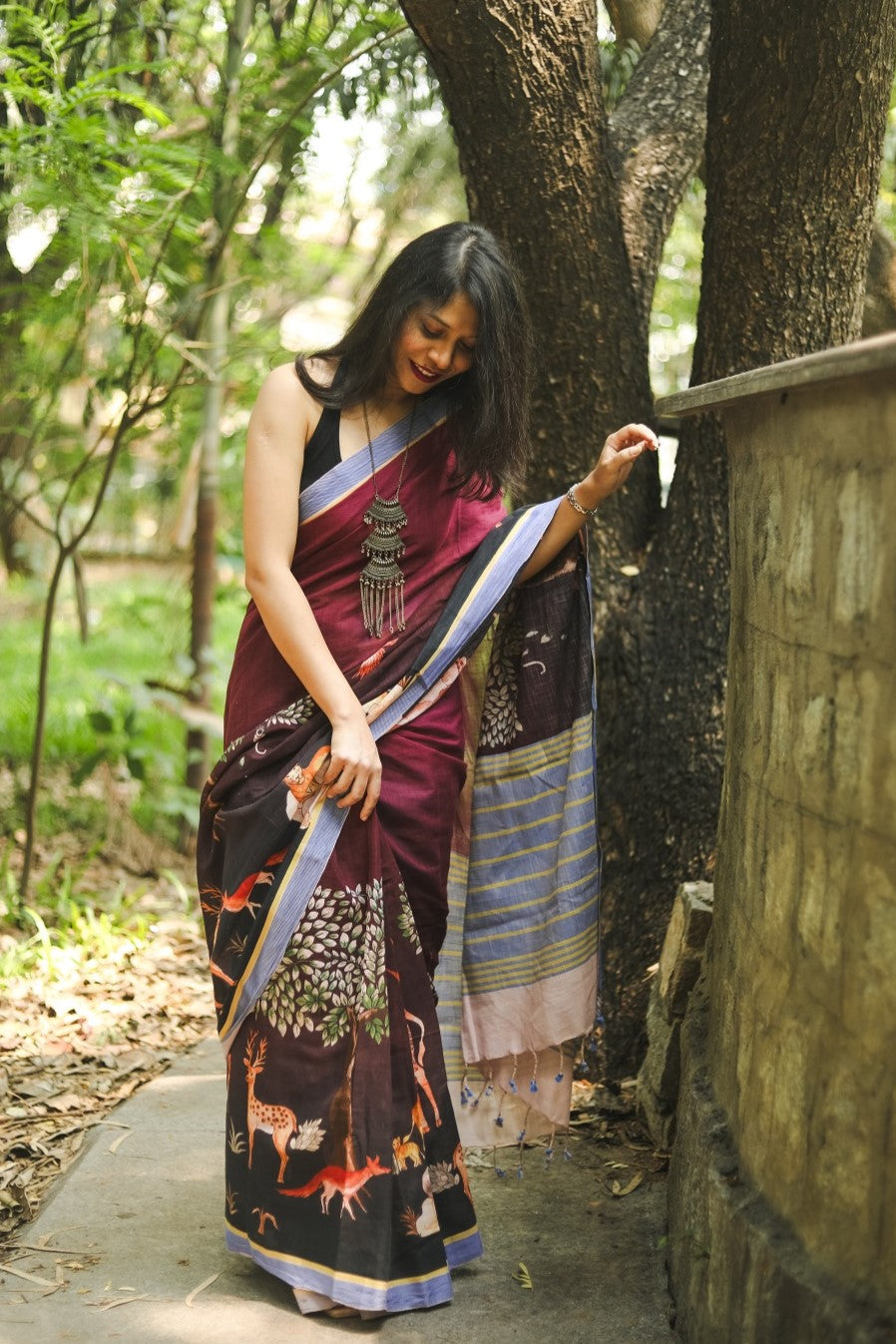 Woman adjusting an animal print saree