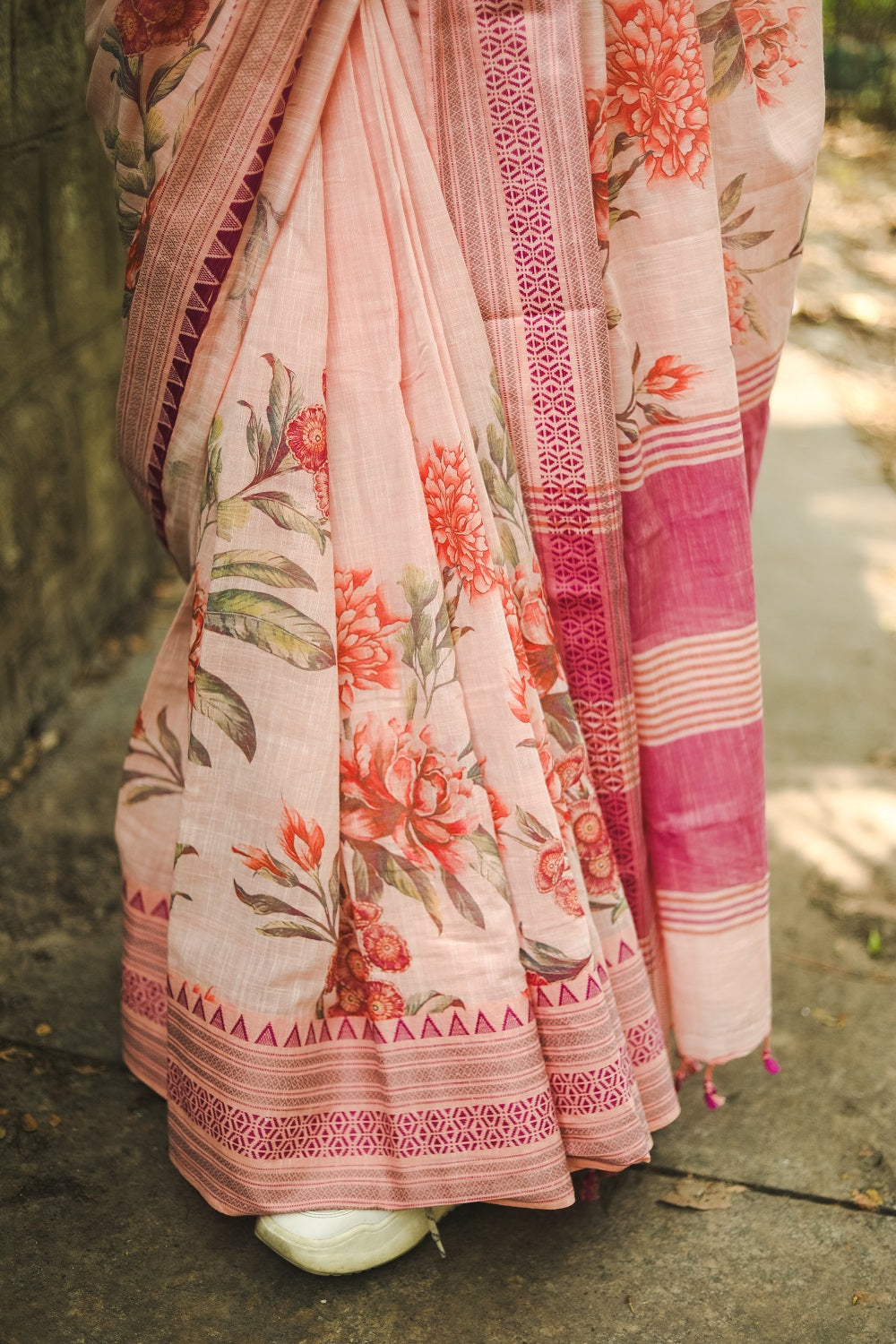 Drape of a pastel pink floral printed khadi cotton saree 